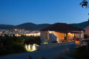 a house with a view of a city at night at Apartments Jobst in Vela Luka