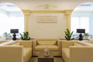 - une salle d'attente avec des canapés et une table dans l'établissement Hotel Boccaccio-free parking-, à Milano Marittima