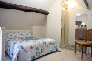 a bedroom with a bed and a walk in shower at gite-civray-de-touraine Maison de Denise in Civray-de-Touraine
