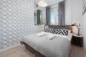 Posteľ alebo postele v izbe v ubytovaní Apartament ProBaltica II Gdynia