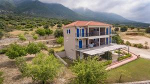 an aerial view of a house with mountains in the background at Regina apartments Simotata Sissia in Lourdata