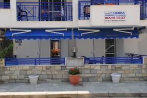 a building with blue balconies and a sign on it at House Katerina Mediterranean in Sarti