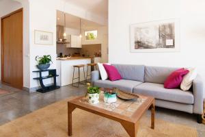 a living room with a couch and a table at Beach and the City Apartment in Málaga