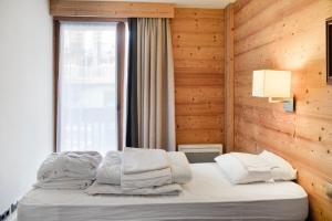 Postel nebo postele na pokoji v ubytování Residence Les Chalets du Forum - maeva Home