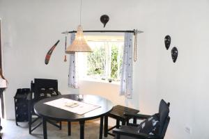 a dining room with a table and chairs and a window at Nyati Hill Cottages in Nairobi