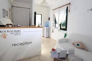 a living room with a white counter and a couch at Koukounari Apartments in Skala +37 photos