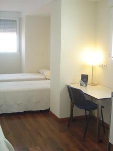 Posteľ alebo postele v izbe v ubytovaní Hostal El Estudio