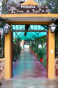 a walkway leading into a building with a sign on it at La Casa de Reyes Posada in Reyes