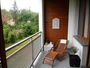 two chairs sitting on a porch with a view at apartament Fanaberia in Zwierzyniec