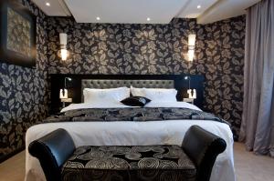 Un ou plusieurs lits dans un hébergement de l'établissement Art Palace Suites & Spa