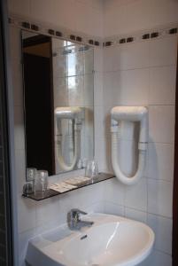 a bathroom with a sink and a mirror at Residence De La Tour Paris-Malakoff in Malakoff