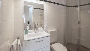 a bathroom with a toilet and a sink and a shower at Achilleon III in Geesthacht +37 photos