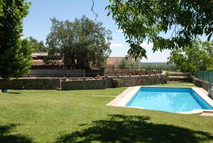 a swimming pool in the yard of a house at B&B Yeguada La Parrilla in El Escorial