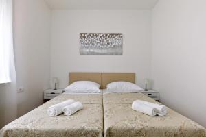 Posteľ alebo postele v izbe v ubytovaní Apartments LUSANI