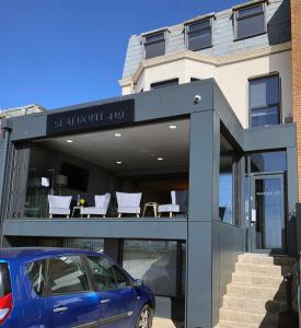 a blue car parked in front of a building at Seafront419 By Seafront Collection in Blackpool