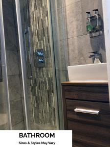 a bathroom with a shower and a sink at Seafront419 By Seafront Collection in Blackpool