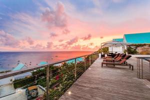 a deck with chairs and a view of the ocean at CeBlue Villas in The Valley