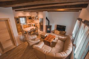 a living room with a couch and a table at Apartmány Štefanova in Terchová