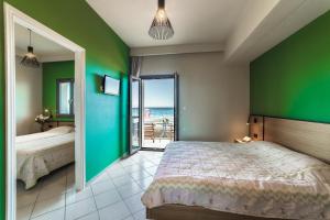 a bedroom with a bed and a view of the ocean at Tropical Beach B in Amoudara Herakliou