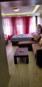 a room with two beds and a couch and a table at RİXOS PERA Apartment in Istanbul