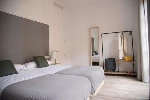 Postel nebo postele na pokoji v ubytování Apartamentos Core Suite Sevilla