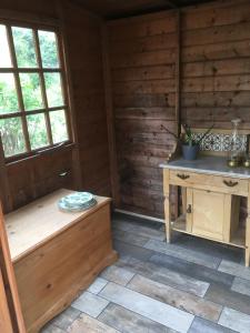 a room with a bench and a table in a cabin at The Cottage in Sulgrave