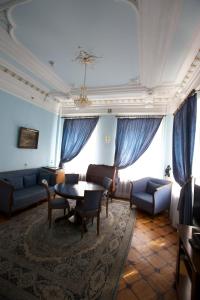 a living room filled with furniture and a large window at Sergievskaya Hotel in Nizhny Novgorod