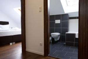 a bathroom with a toilet and a sink at Hotel Teatro in Kassel +37 photos