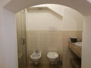 a bathroom with a shower and a toilet and a sink at Solis Domus - Meridies in Ostuni +11 photos
