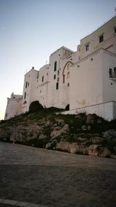 a large white building on top of a hill at Solis Domus - Meridies in Ostuni +11 photos