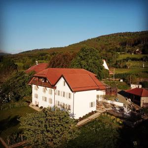 an aerial view of a white house with a red roof at La Ferme de la Praz - Rooms with a View in La Praz