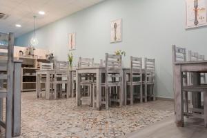 a room with chairs and a table with a rug at Hotel Mica in Palas de Rei