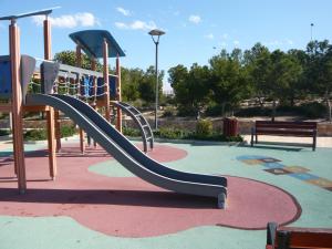 a playground with a slide in a park at Aitana Apartment in Gran Alacant