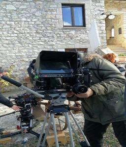 a man in front of a camera on a tripod at Il Vallone di Melezzole in Melezzole