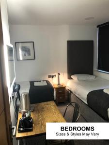 a hotel room with two beds and a table at Seafront419 By Seafront Collection in Blackpool