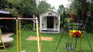 a playground with a gazebo in a yard at The Yardt Guest House in Trichardt