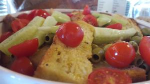 a bowl of food with tomatoes and other vegetables at Hotel Boutique Il Castellino Relais in Vieste