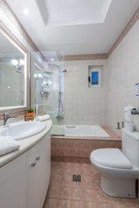 a bathroom with a tub and a toilet and a sink at Sea and the city in Rhodes Town +41 photos