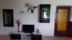 a living room with a tv on a white wall at Apartmani Marenda in Supetarska Draga