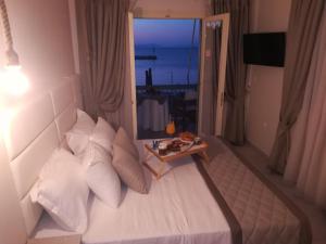 a bedroom with a bed with a table and a window at marilena in Nea Epidavros