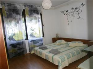 a small bedroom with a bed in a room at Apartmani Marenda in Supetarska Draga