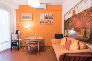 a living room with a couch and a table at Roommo Savonarola in Florence +7 photos