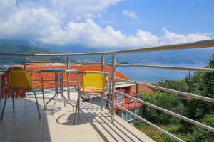 a balcony with chairs and a view of the water at Ana in Budva