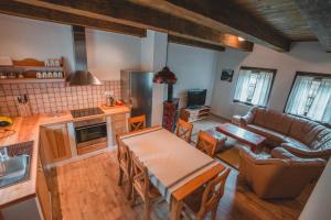 a kitchen and living room with a table and a couch at Apartmány Štefanova in Terchová