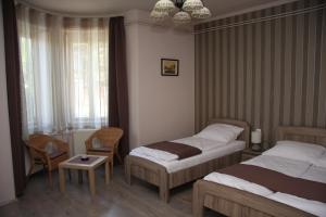 En eller flere senge i et værelse på Villa Maria Apartman