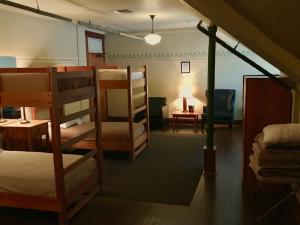 a dorm room with bunk beds and a desk at McMenamins Edgefield in Troutdale
