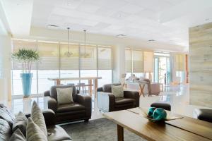 a living room with a couch and chairs and a table at Hotel Expo Abastos in Guadalajara