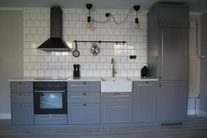 a kitchen with a stove and a tv in it at Charmigt i centrala Ystad in Ystad