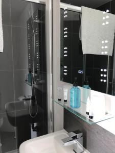 a bathroom with a sink and a mirror at Palma Guest House in St Ives