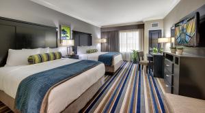 a hotel room with two beds and a desk at Cypress Bayou Casino Hotel in Franklin